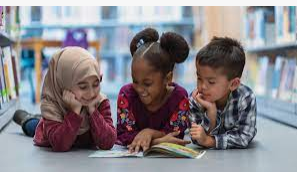 A girl holding a sign that says racism is also a pandemic.