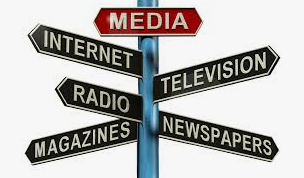 A girl holding a sign that says racism is also a pandemic.