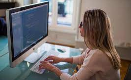 A girl holding a sign that says racism is also a pandemic.